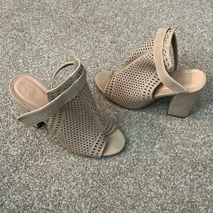 Women’s high heeled open toed sandals. 4” heel. Buckle closure.